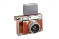 Aparat Lomography Lomo'Instant Wide Central Park obok gotowych odbitek z filmu Instax Wide.